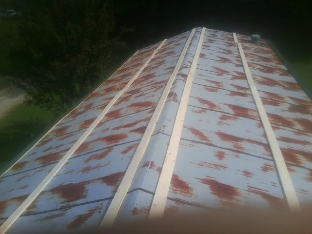 Rusted metal roof panels with new wood purlins before replacement — Storm Damage Roof Repair in Lanark by Roofing Brothers